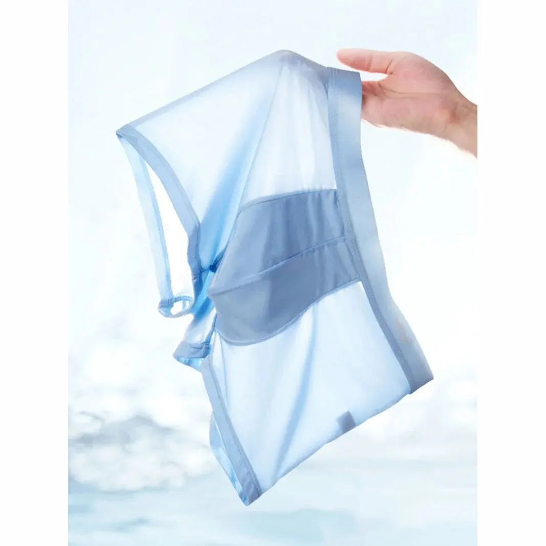 Hand holding a blue mesh laundry bag with a white background