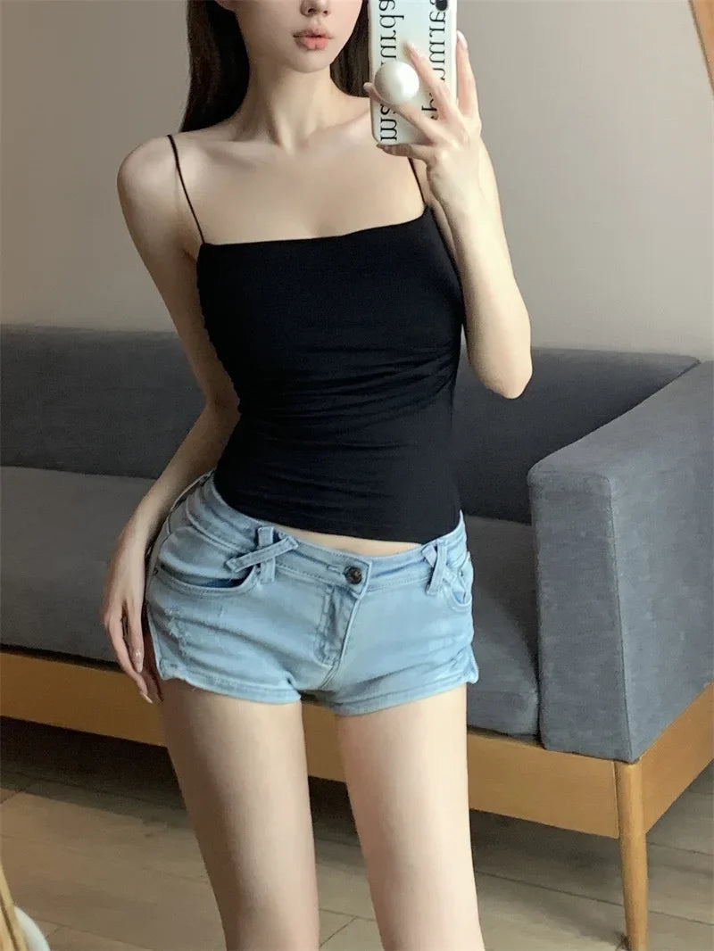 Woman wearing a black ruched sleeveless cami top