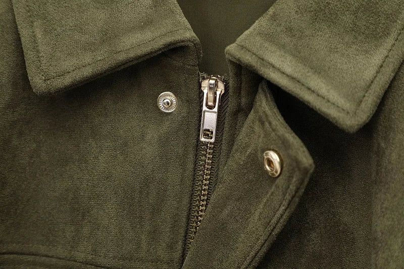 Close-up of a green jacket with a zipper and buttons.