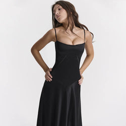 Woman wearing a black dress against a white background