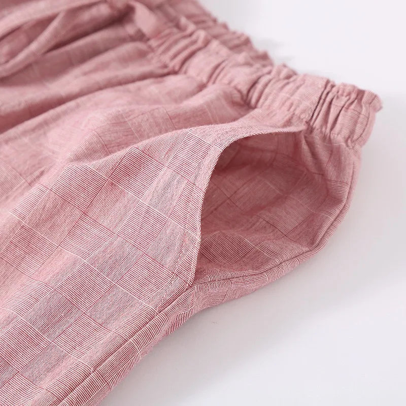 Close-up of pink textured fabric on a white background
