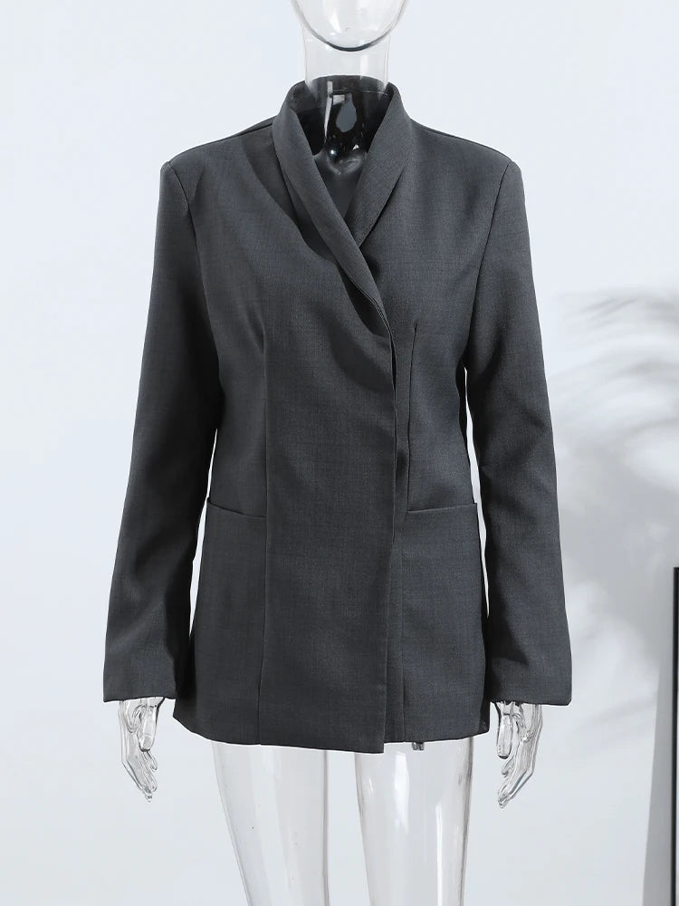 Gray blazer on a mannequin against a white background