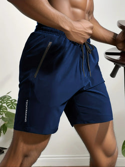 A pair of navy blue sports shorts with a drawstring waist, shown on a male model. | 3KDyn