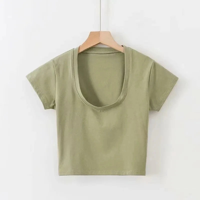 Green t-shirt on a wooden hanger against a white background