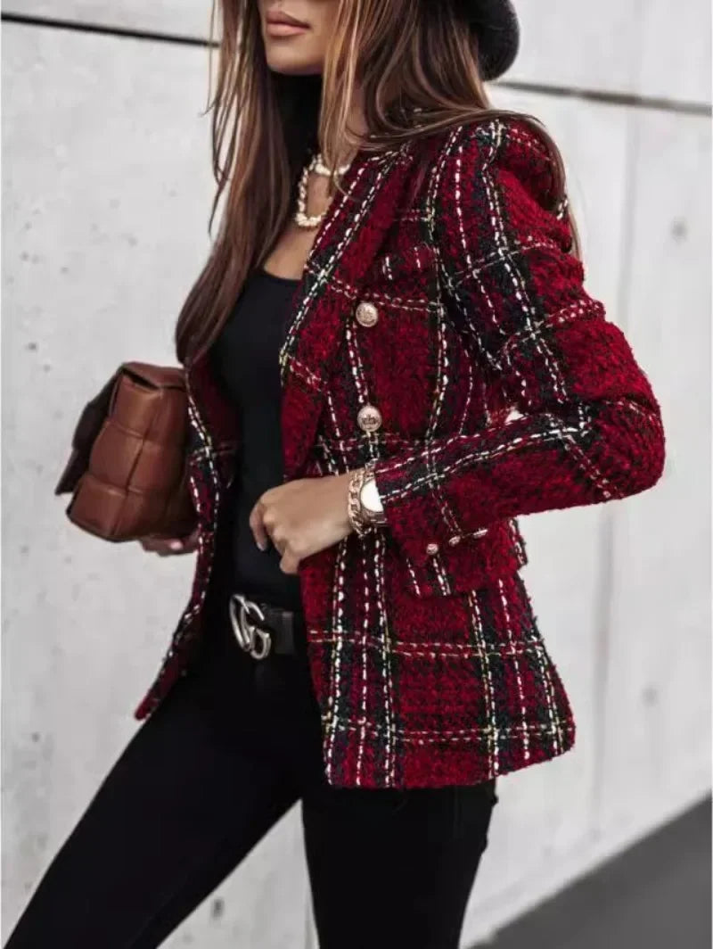 Person wearing a red plaid coat with a blurred background