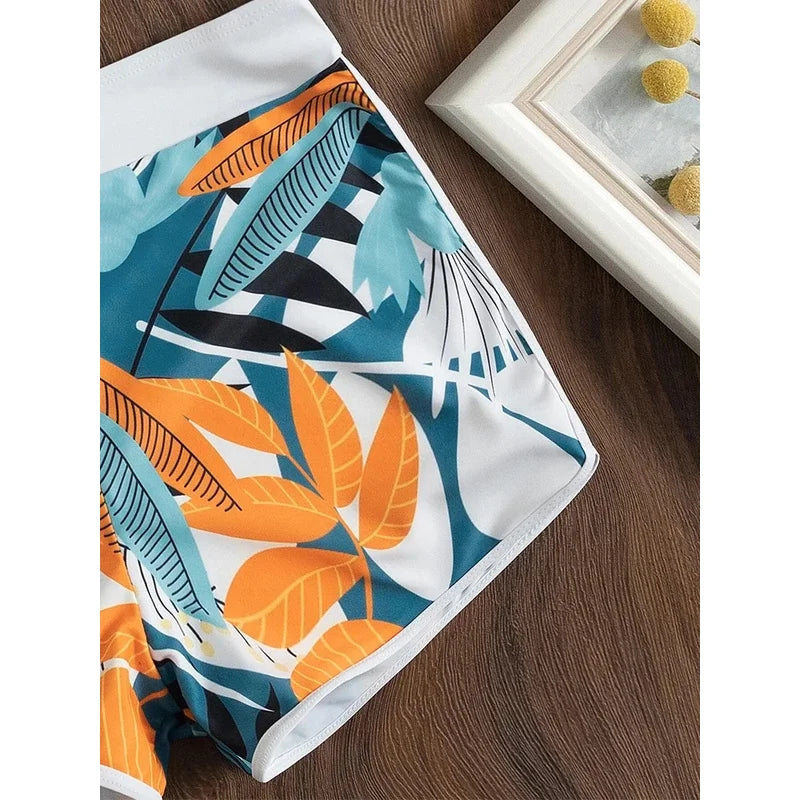 Colorful leaf-patterned towel on a wooden surface