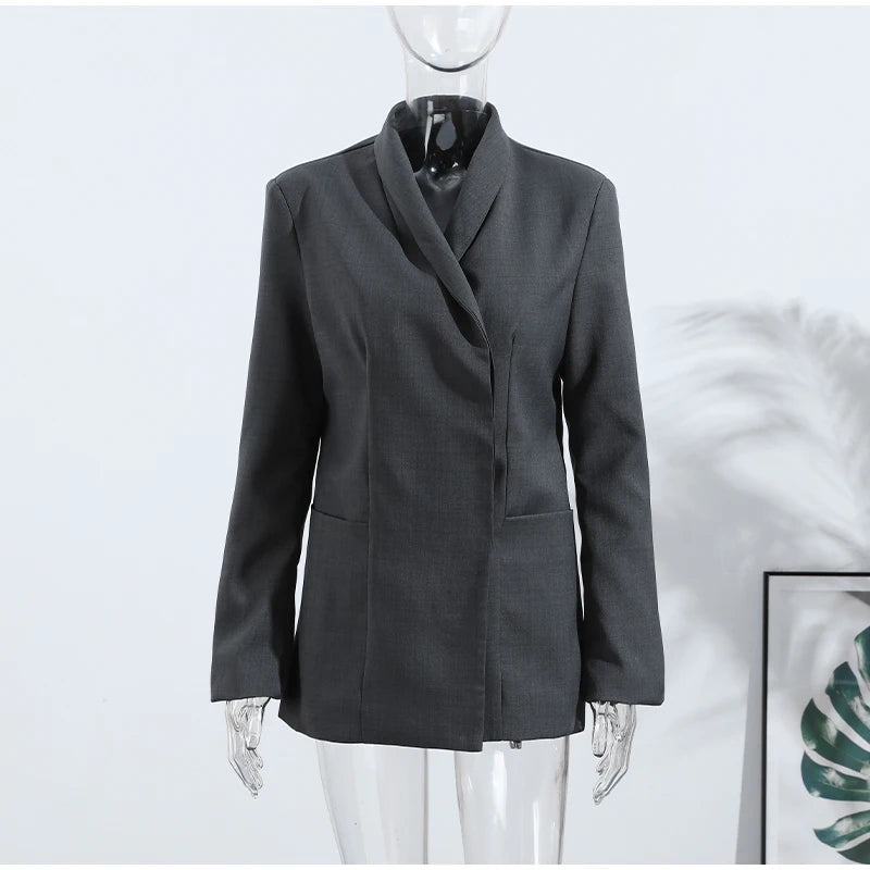 Gray blazer on a mannequin against a white background