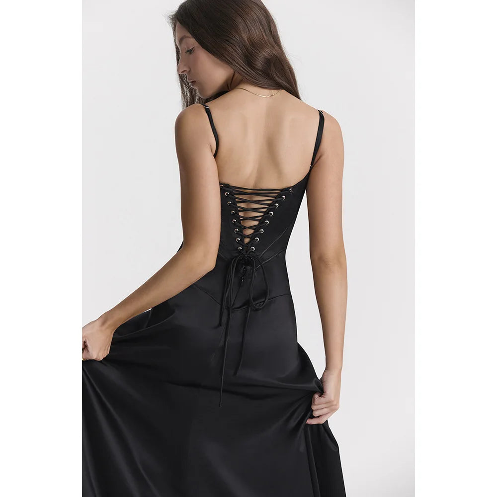 Black dress with lace-up back worn by a model on a white background