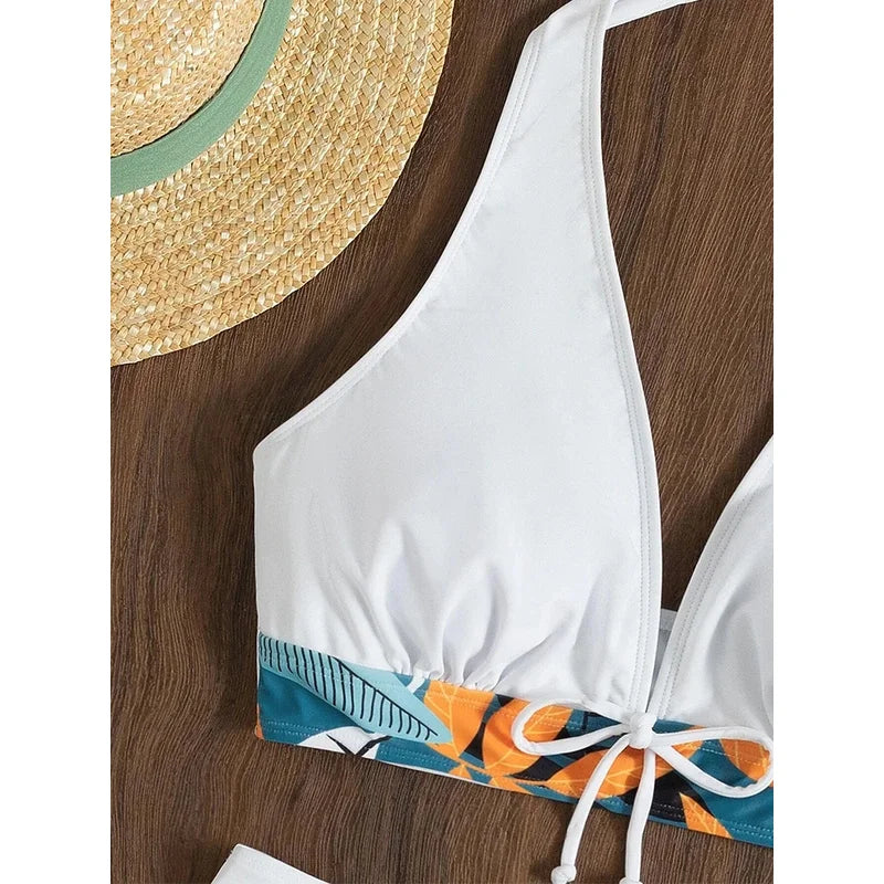 White bikini top with colorful design on a wooden surface
