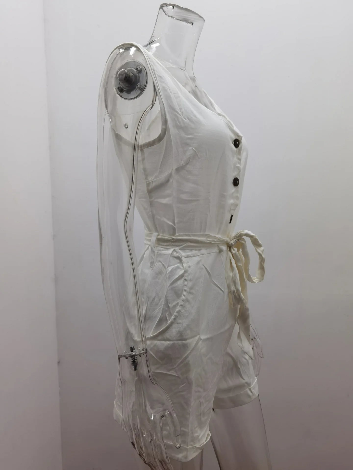 White outfit on a mannequin against a plain background