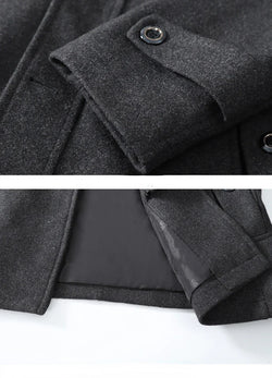 Close-up of a dark gray coat with buttons on a white background