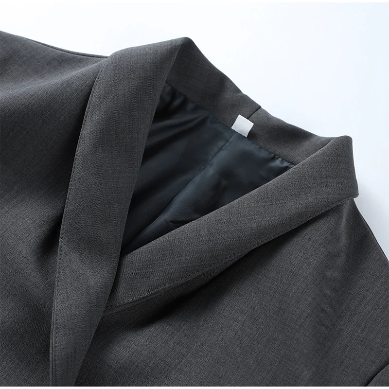 Gray suit jacket with a close-up of the collar and label on a white background