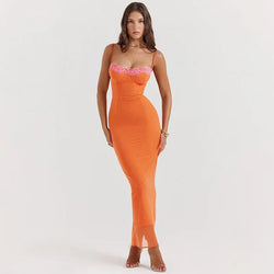 Woman wearing an orange dress with pink lace details on a white background