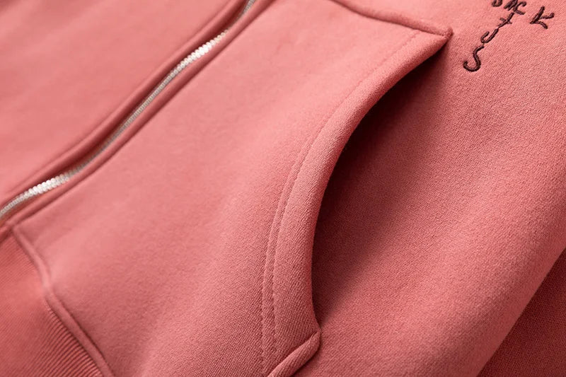 Close-up of a pink jacket with a brand logo on a matching background
